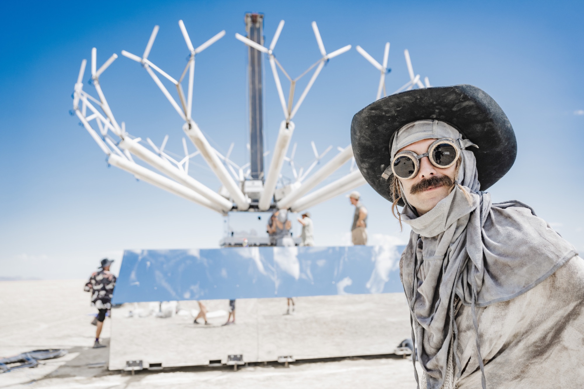 Singularity Tree mid-build on the Black Rock playa — mirrored base, branching volumetric structure, crew at work
