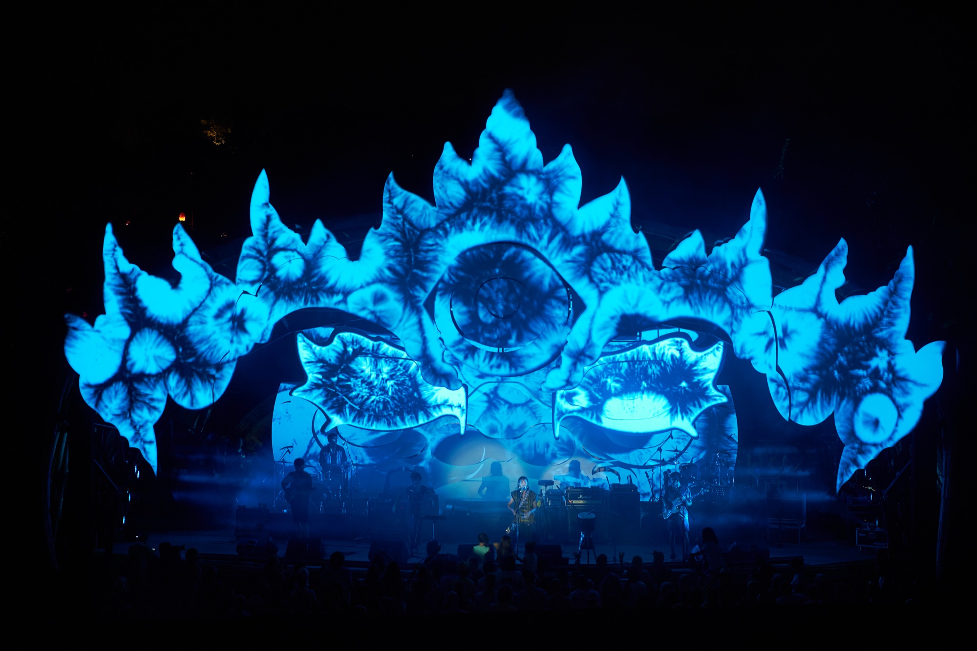 Suara Festival main stage — sculptural set fully projection-mapped in blue, live band performing